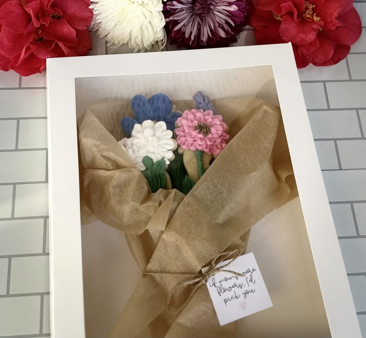 A bouquet of flowers in a case with a label on it.